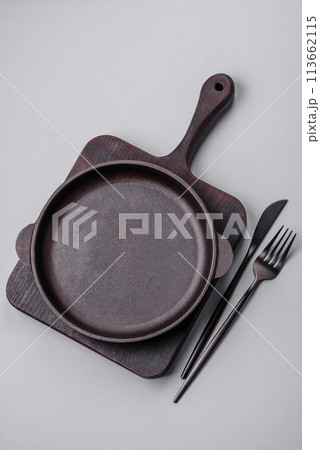 An empty plate on a gray concrete background with copy space An empty plate on a gray concrete background with copy space 113662115