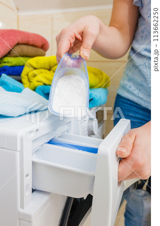 Hand pour washing powder into machine 113662250