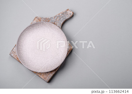 An empty plate on a gray concrete background with copy space An empty plate on a gray concrete background with copy space 113662414
