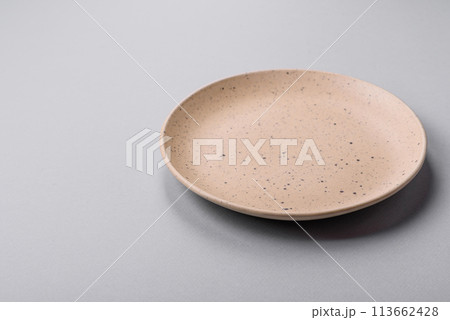 An empty plate on a gray concrete background with copy space 113662428