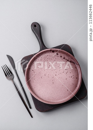 An empty plate on a gray concrete background with copy space 113662446