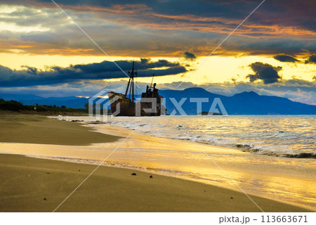 Rusty broken shipwreck on sea shore 113663671