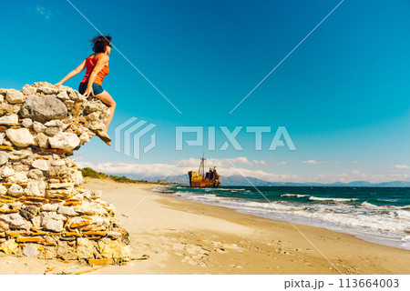Tourist woman on beach enjoying vacation Tourist woman on beach enjoying vacation 113664003