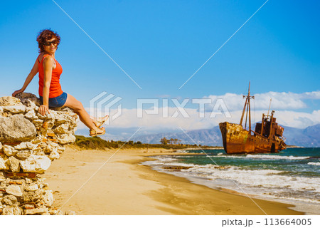 Tourist woman on beach enjoying vacation Tourist woman on beach enjoying vacation 113664005