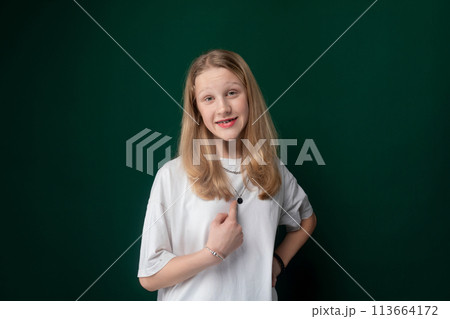 Woman Standing in Front of Green Wall Woman Standing in Front of Green Wall 113664172