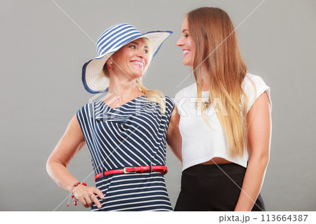 Fashionable mother and daughter posing together 113664387