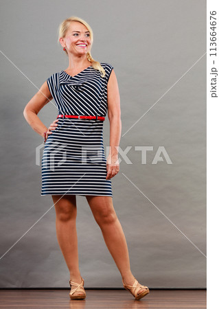 Mid adult woman in summer striped dress 113664676