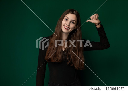 Woman Posing in Front of Green Background Woman Posing in Front of Green Background 113665072