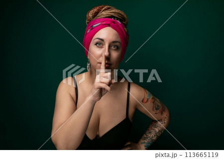Woman in Pink Turban Making a Hush Gesture Woman in Pink Turban Making a Hush Gesture 113665119