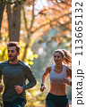 Man and Woman Running in the Woods 113665132
