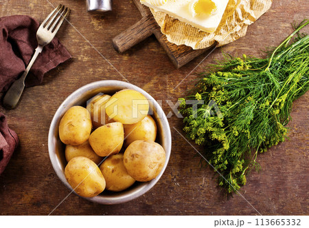 Fresh raw baby potato in bowl on wooden background. 113665332