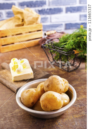 Fresh raw baby potato in bowl on wooden background. Fresh raw baby potato in bowl on wooden background. 113665337