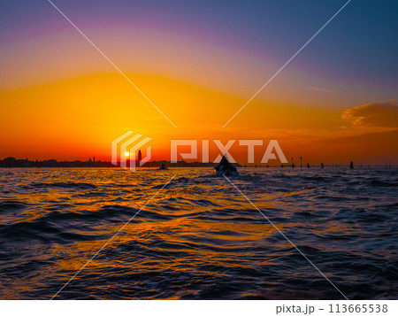 silhouettes of Venice at sunset , view from water 113665538