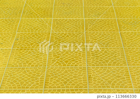 Bright yellow floor tile stone ceramic abstract mosaic pattern surface street road city texture background 113666330