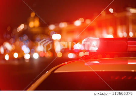 Police car red color emergency light (siren) at the night city lights background. 113666379