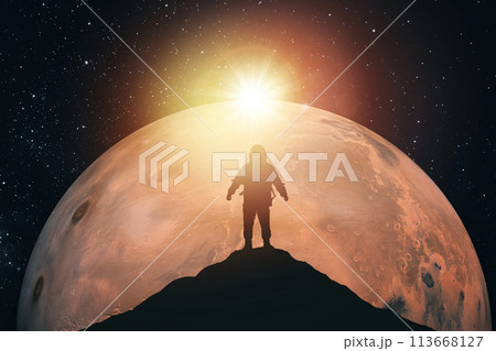 Silhouette of an astronaut on top of a mountain against the background of Mars. Elements of this image furnished by NASA Silhouette of an astronaut on top of a mountain against the background of Mars. Elements of this image furnished by NASA 113668127