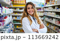 Inside the Drugstore, Smiling and Confident Young Female Pharmacist with Arms Crossed, Generative AI 113669242