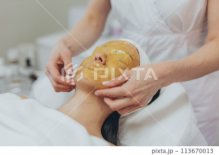 A girl at a cosmetologist does cosmetic procedures. Alginate mask A girl at a cosmetologist does cosmetic procedures. Alginate mask 113670013