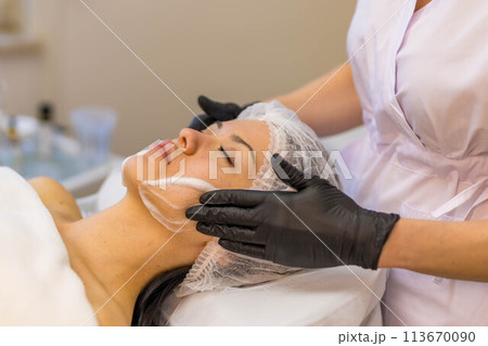woman at the cosmetologist. She has problem skin and acne. woman at the cosmetologist. She has problem skin and acne. 113670090