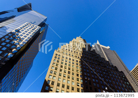 Manhattan, New York City USA modern city urban scape with skyscrapers business office buildings from bottom up. 113672995