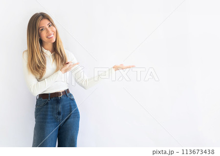 Close up photo of pretty cheerful woman stylish white clothes arm direct empty space Close up photo of pretty cheerful woman stylish white clothes arm direct empty space 113673438