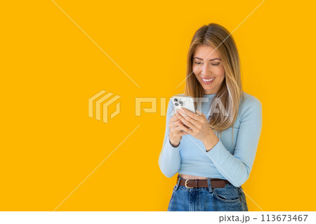 Caucasian businesswoman in formal attire in her office happy and cheerful while using smartphones Caucasian businesswoman in formal attire in her office happy and cheerful while using smartphones 113673467