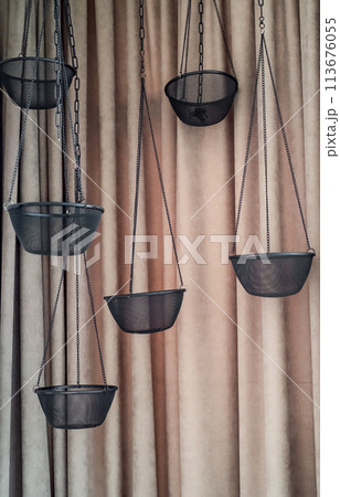 Empty hanging pot for orchids against white bricks wall 113676055