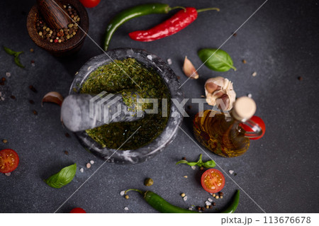 stone marble mortar with green capers, fennel and basil sauce stone marble mortar with green capers, fennel and basil sauce 113676678