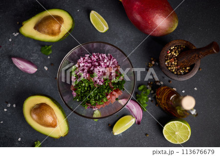 cooking traditional tuna tartare - chopped tuna, cilantro and onion in a glass bowl cooking traditional tuna tartare - chopped tuna, cilantro and onion in a glass bowl 113676679