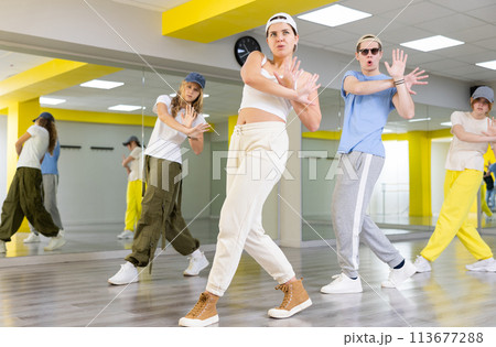 Young girl in cap dancing hip hop Young girl in cap dancing hip hop 113677288