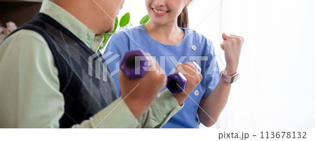 Asian caregiver woman or nurse training senior man lifting dumbbell for arm exercise. Asian caregiver woman or nurse training senior man lifting dumbbell for arm exercise. 113678132