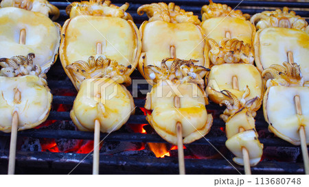 Picture of grilled squid in Thai style, eat with spicy seafood dipping sauce. Photos of street food in Thailand Picture of grilled squid in Thai style, eat with spicy seafood dipping sauce. Photos of street food in Thailand 113680748