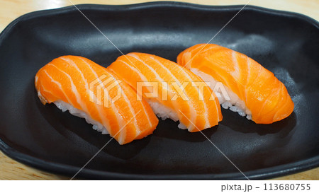 Salmon sushi on a wooden background. Use for illustrations, background images, or copy space. 113680755