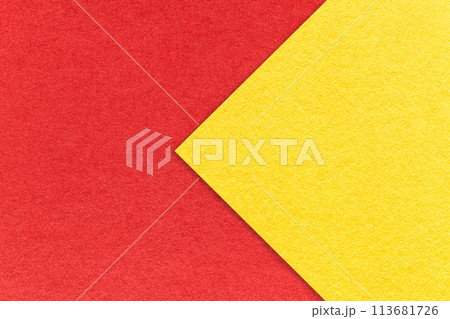 Texture of red paper background, half two colors with yellow arrow, macro. Vintage craft cardboard. 113681726