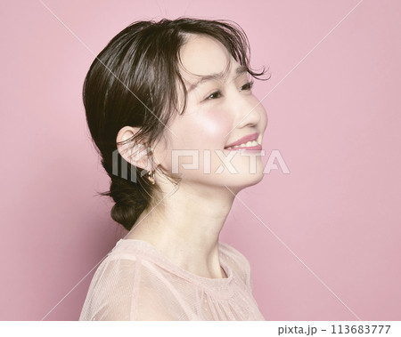ピンク背景で撮影した若い華やかな女性のポートレート 113683777