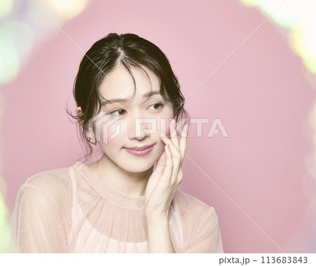 ピンク背景で撮影した若い華やかな女性のポートレート 113683843