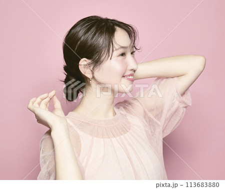 ピンク背景で撮影した若い華やかな女性のポートレート ピンク背景で撮影した若い華やかな女性のポートレート 113683880