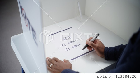 African American man votes for presidential candidate or political party 113684320