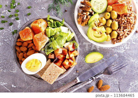 salad with salmon, boiled egg, bean, tomato, salad and almond nuts. 113684465