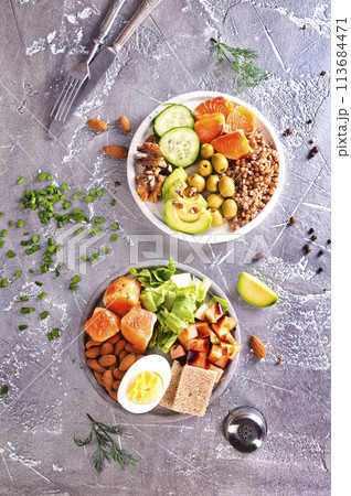 salad with salmon, boiled egg, bean, tomato, salad and almond nuts. salad with salmon, boiled egg, bean, tomato, salad and almond nuts. 113684471
