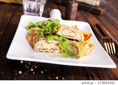 Dashimaki tamago, Japanese style rolled omelette in dish on wooden table 113684482