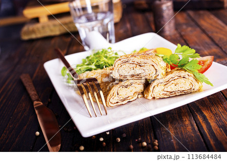 Dashimaki tamago, Japanese style rolled omelette in dish on wooden table Dashimaki tamago, Japanese style rolled omelette in dish on wooden table 113684484