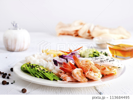 boiled rice with avocado and fried shrimps boiled rice with avocado and fried shrimps 113684495