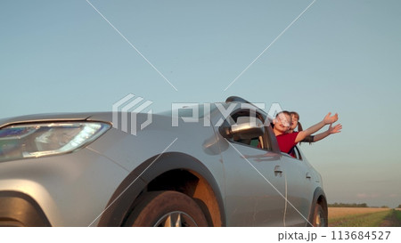 boy girl car window cheerfully waving hands, happy children journey, wind child hair, dream flying, car carries kid sister brother family trip, happy family, kindergarten, family trip car vacation, 113684527