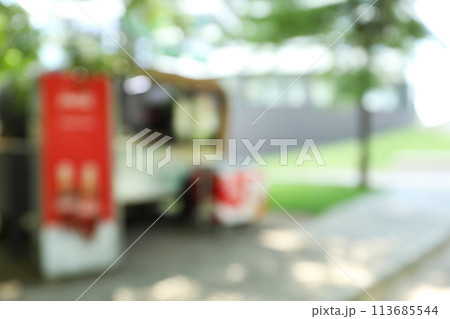 Blurred city photo with trees and houses 113685544