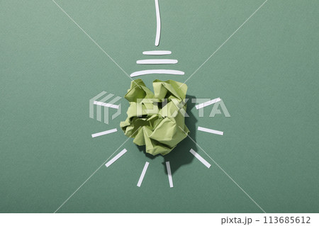 A light bulb made of crumpled paper, the concept of an eco house 113685612