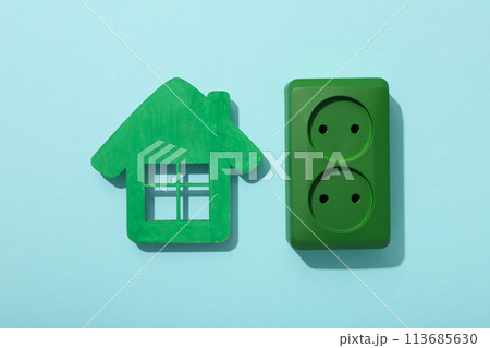 Decorative house with a green electrical outlet 113685630
