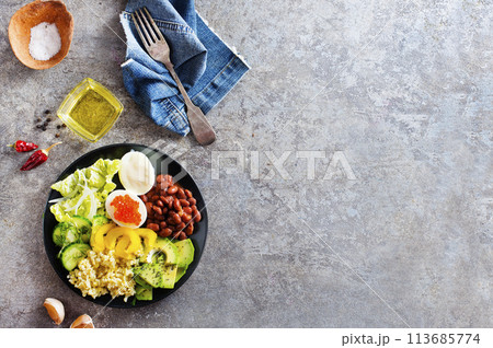 Buddha bowl, balanced food, vegetarian menu. Eggs, avocado, salad lettuce, bulgur, spice Buddha bowl, balanced food, vegetarian menu. Eggs, avocado, salad lettuce, bulgur, spice 113685774
