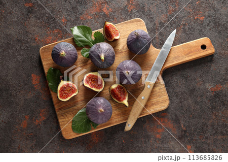 Fresh ripe figs with a knife on a wooden board Fresh ripe figs with a knife on a wooden board 113685826