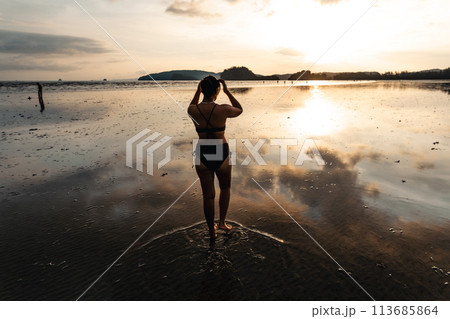 summer travel,Woman walking on the beach in the evening summer travel,Woman walking on the beach in the evening 113685864